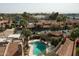 Aerial view featuring a pool, lush landscaping, and nearby residences in a vibrant community at 4442 E Camelback Rd # 161, Phoenix, AZ 85018