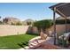 Serene backyard featuring manicured synthetic grass, lounge seating, and desert landscaping at 4442 E Camelback Rd # 161, Phoenix, AZ 85018