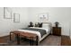 Bright bedroom featuring a stylish rug, bench, and bedside tables with lamps on either side of the bed at 4442 E Camelback Rd # 161, Phoenix, AZ 85018