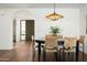 Bright dining room featuring stylish light fixtures, a modern dining table, and hardwood floors at 4442 E Camelback Rd # 161, Phoenix, AZ 85018