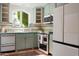 Charming kitchen with classic appliances, tiled countertops, and a garden view window at 4442 E Camelback Rd # 161, Phoenix, AZ 85018