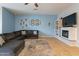 Comfortable living room with a modern fireplace, integrated shelving, and a large, cozy couch for relaxing entertainment at 4521 W Hopi Trl, Laveen, AZ 85339