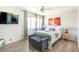 Bright bedroom with mounted TV, ceiling fan, and neutral accent wall at 4620 N 68Th St # 117, Scottsdale, AZ 85251