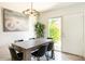 Bright dining room featuring modern chandelier, painting, table, and chairs at 4620 N 68Th St # 117, Scottsdale, AZ 85251