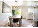 Cozy dining room featuring modern lighting and an adjacent kitchen area at 4620 N 68Th St # 117, Scottsdale, AZ 85251