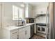 Modern kitchen with stainless steel appliances and white cabinets at 4620 N 68Th St # 117, Scottsdale, AZ 85251