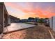 Backyard featuring a concrete slab with a colorful sunset in the background at 4895 E Amarillo Dr, San Tan Valley, AZ 85140