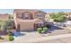 Inviting two-story home with brick accents, mature landscaping, and a two-car garage for convenience at 4895 E Amarillo Dr, San Tan Valley, AZ 85140