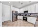 This is a bright kitchen with white cabinets, stainless steel appliances, and tile floors at 4895 E Amarillo Dr, San Tan Valley, AZ 85140