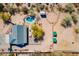 Aerial view of the property highlighting the pool, horse corral, covered stables and home at 532 N 102Nd Pl, Mesa, AZ 85207
