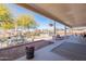 Spacious backyard featuring a covered patio, dining area, grill, and well-maintained desert landscaping at 532 N 102Nd Pl, Mesa, AZ 85207
