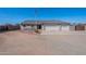 Charming single-story home featuring a three-car garage, desert landscaping, and a flagpole displaying the American flag at 532 N 102Nd Pl, Mesa, AZ 85207