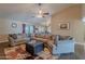 Cozy living room with a sectional sofa, ceiling fan, and sliding glass doors for plenty of natural light at 532 N 102Nd Pl, Mesa, AZ 85207