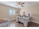 Home office featuring a large desk, window with shutters, wood floors, and neutral decor at 532 N 102Nd Pl, Mesa, AZ 85207