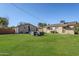 Spacious backyard features lush green grass, stone buildings, and comfortable seating at 541 W Edgemont Ave, Phoenix, AZ 85003