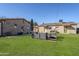 Spacious backyard features lush green grass, stone buildings, and comfortable seating at 541 W Edgemont Ave, Phoenix, AZ 85003