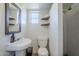 Cozy bathroom featuring a rustic wood shelf, classic sink and walk-in shower at 541 W Edgemont Ave, Phoenix, AZ 85003
