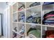 Shelved closet area with a variety of stacked folded clothing at 541 W Edgemont Ave, Phoenix, AZ 85003