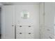 Hallway includes shoe storage, storage closet, and a round mirror hanging on the wall at 541 W Edgemont Ave, Phoenix, AZ 85003