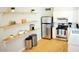 Bright kitchen with stainless steel appliances, white cabinets, and open shelving at 541 W Edgemont Ave, Phoenix, AZ 85003