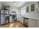 Updated kitchen featuring stainless steel appliances, white cabinets, and subway tile backsplash at 541 W Edgemont Ave, Phoenix, AZ 85003