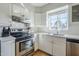 Modern kitchen with stainless steel appliances, white subway tile, and quartz countertops at 541 W Edgemont Ave, Phoenix, AZ 85003