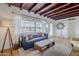 Comfortable living room featuring wood floors, a blue sofa, and plenty of natural light at 541 W Edgemont Ave, Phoenix, AZ 85003