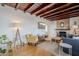 Inviting living room featuring wood beam ceiling, stone fireplace, and hardwood floors at 541 W Edgemont Ave, Phoenix, AZ 85003