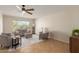 Bright living room features tile flooring, modern ceiling fan, and ample natural light at 5910 E Colby St, Mesa, AZ 85205