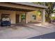 Front exterior showing house number and a golf cart parked in the carport at 619 S Desert Flower Dr, Mesa, AZ 85208