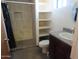 This bathroom features tiled walls, a shower, shelving, granite countertops and a sink at 639 W Us Highway 60 Hwy, Superior, AZ 85173