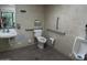This bathroom has a toilet and a sink with handicap railing around the room at 639 W Us Highway 60 Hwy, Superior, AZ 85173