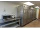Kitchen area featuring stainless steel appliances, including refrigerators, microwave, and storage racks at 639 W Us Highway 60 Hwy, Superior, AZ 85173