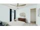 Stylish bedroom with tile floors, a modern dresser, ample closet space, and a ceiling fan at 724 S Lewis --, Mesa, AZ 85210