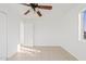 Bright bedroom with tiled floors, ceiling fan, with open door to adjacent space at 724 S Lewis --, Mesa, AZ 85210