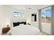 Comfortable bedroom features a large bed, modern light fixture, and a view from the window at 724 S Lewis --, Mesa, AZ 85210