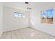 Neutral bedroom with tile flooring, white walls, and a window providing natural light at 724 S Lewis --, Mesa, AZ 85210