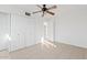 Neutral bedroom featuring tiled flooring, a ceiling fan and a closet with white doors at 724 S Lewis --, Mesa, AZ 85210