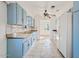 Bright kitchen featuring blue cabinets, a ceiling fan, and tiled floors at 724 S Lewis --, Mesa, AZ 85210