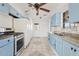Cozy kitchen featuring blue cabinets, stainless steel appliances, tile floors and granite countertops at 724 S Lewis --, Mesa, AZ 85210