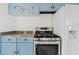 Kitchen featuring appliances including a stove and refrigerator, with light blue cabinets at 724 S Lewis --, Mesa, AZ 85210
