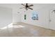 Bright living room featuring tile floors, white walls, and a ceiling fan with natural light from multiple windows at 724 S Lewis --, Mesa, AZ 85210