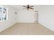 Bright living room with tile floors, neutral walls and ceiling fan at 724 S Lewis --, Mesa, AZ 85210