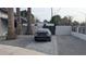 Car parked in the driveway of a home with desert landscaping and a security gate at 753 W 6Th Dr, Mesa, AZ 85210