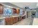 Kitchen with tile flooring, wood cabinets and view into the living room at 7548 E Minnezona Ave, Scottsdale, AZ 85251