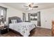 This comfortable bedroom features wood-look tile floors and gray window coverings for a cozy ambiance at 7916 E Monte Ave, Mesa, AZ 85209