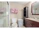 Well-lit bathroom featuring a tiled shower and vanity with granite countertop at 8155 E Roosevelt St # 112, Scottsdale, AZ 85257