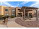 Outdoor common area with covered seating, landscaping, and pathways at 8155 E Roosevelt St # 112, Scottsdale, AZ 85257