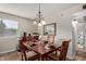 Dining area with wood table, seating for four, and elegant chandelier at 8155 E Roosevelt St # 112, Scottsdale, AZ 85257