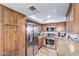 Well-lit kitchen featuring stainless steel appliances and ample cabinet space at 8155 E Roosevelt St # 112, Scottsdale, AZ 85257